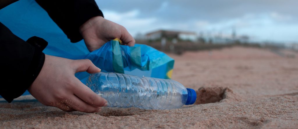 person-holding-clear-plastic-bottle-3480494